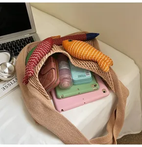 Spacious beige knit tote bag showing large capacity with daily essentials and tablet