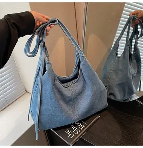 Mirror reflection showing details of the large retro blue denim hobo shoulder bag