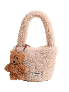 Chic beige faux shearling bucket bag with cute bear charm and soft teddy plush texture
