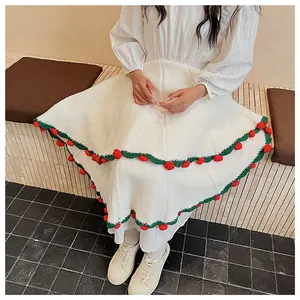 Detail of waffle knit blanket with green scalloped edges and 3D red crochet roses