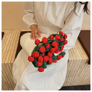 Detail of handmade crochet rose bouquet pillow with red roses and white heart-shaped base
