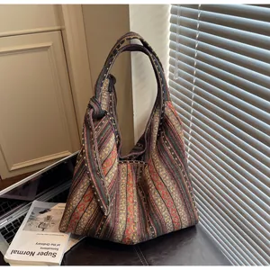 Detailed close-up of Bohemian woven shoulder bag with colorful ethnic diamond patterns