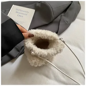 Interior detail of a white plush crossbody bag showing space for phone and small items