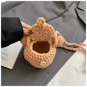 Close-up of pink crochet bear bag with with love engraved wooden button detail