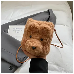 Close-up of brown plush teddy bear crossbody bag featuring fuzzy ears and soft texture