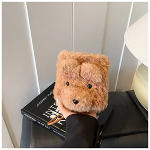 Detail of soft brown plush bear bag showing furry texture and cute cartoon facial features