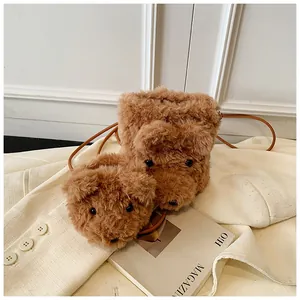 Detailed view of the plush brown bear bags with soft curly faux fur and leather straps