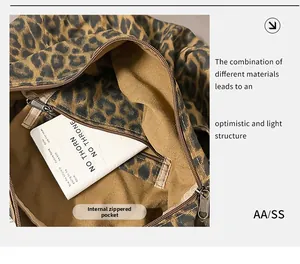 Detail of inner zipper pocket and leopard canvas material on the spacious shoulder bag
