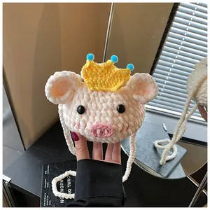 Detailed view of handmade crochet pig bag with plush texture and cute crown decoration