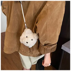 Detail of cute plush bear crossbody bag worn by a model in a stylish casual outfit