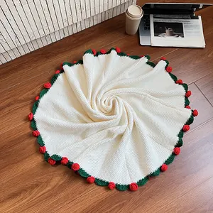 Handmade rose crochet blanket with red floral edge and white knit texture on floor