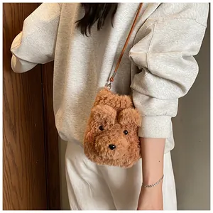 Detailed close-up of a brown plush dog-shaped crossbody bag worn by a model in casual attire