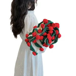 Handmade knitted blanket with red 3D roses and green wavy edges on cream background