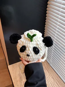 Handmade crochet panda shoulder bag with sprout leaf detail and textured knit pattern