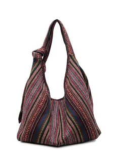 Ethnic bohemian tote bag with colorful woven stripes and a wide knotted shoulder strap