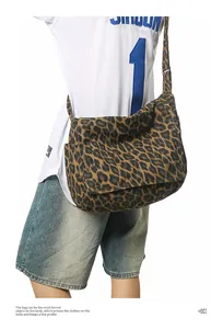 Detail of the leopard print canvas messenger bag showing large capacity and side pocket