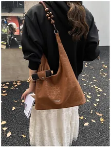 Detail of brown leopard print suede tote bag with unique wooden beaded shoulder strap