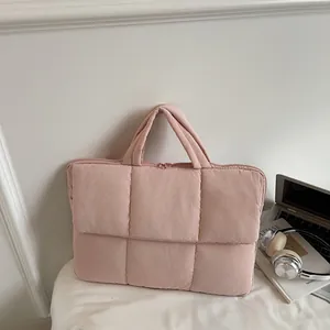 Pink quilted laptop tote bag with vertical stitching and padded top handles
