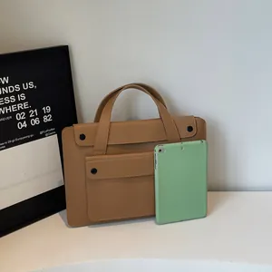 Detail of khaki laptop briefcase with front pocket and mint green tablet for size reference