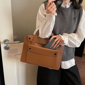 Brown faux leather business briefcase featuring a large front pocket and double handles