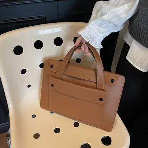 Brown PU leather handbag details featuring elegant flap design and black round buckles