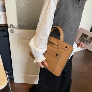 Minimalist brown leather business briefcase with a snap-button front pocket for women