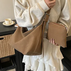 Detail view of dark brown matte leather bucket bag set with matching small zipper pouch