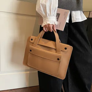 Detail of camel PU leather briefcase with front flap pocket and black snap button closure
