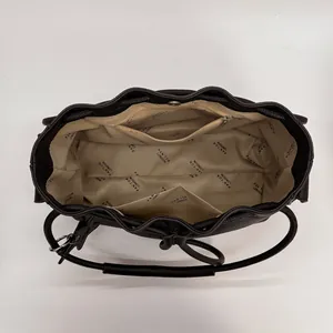 Interior view of black leather bucket bag with multiple pockets and drawstring closure