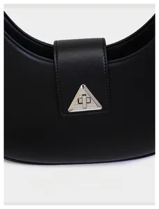 Close-up of black crescent shoulder bag with silver triangle metal lock and lychee texture