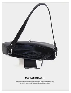Detailed interior of black leather crescent bag with inner zipper and silver hardware