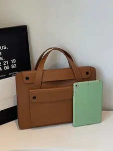 Minimalist brown leather business tote bag for women with front pocket and metal snaps