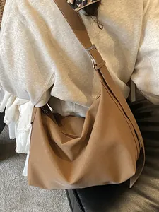 Brown grainy leather hobo shoulder bag with adjustable strap and silver metal buckle