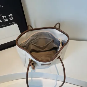 Internal view of large tote bag showing organized pockets and spacious grey lining
