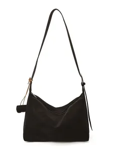 Fashionable black crescent shoulder bag with knotted charm detail and sleek leather finish