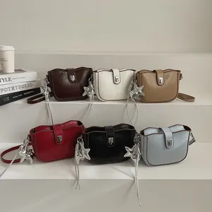 Collection of saddle bags in six colors with star charms and metallic rotary locks
