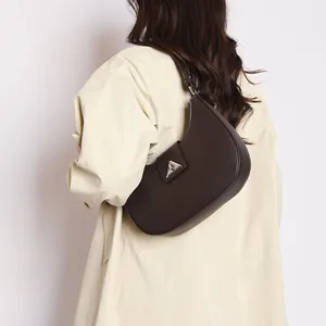 Close-up of dark brown crescent hobo bag in lychee pattern leather with metal buckle