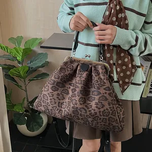 Detail of vintage leopard print cloud bag with metal kiss-lock closure and handle