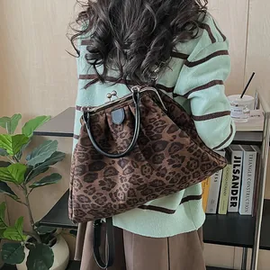 Detail shot of the retro leopard print doctor bag with vintage kiss-lock metal closure