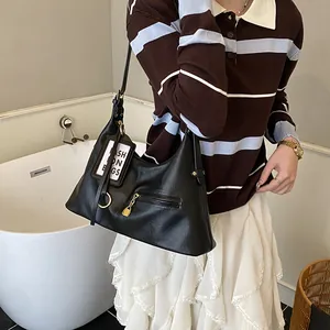 Classic black PU leather underarm bag with gold metal zipper and fashion tags