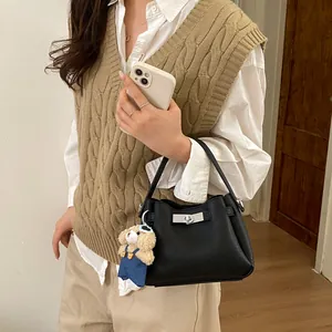 Black litchi grain bucket bag with silver twist lock and cute teddy bear charm