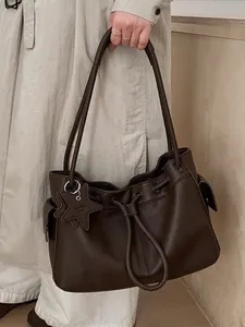 Minimalist dark brown lychee leather tote bag with star charm and drawstring detail