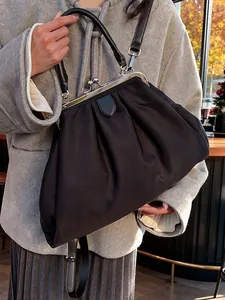 Fashionable black pleated cloud handbag with metal frame kiss-lock and top handle