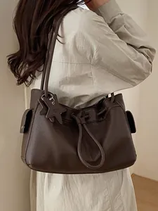 Minimalist dark brown lychee leather tote bag with star pendant and drawstring closure