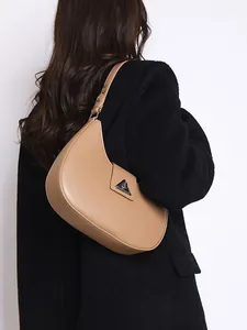 Minimalist light brown crescent hobo bag with silver triangle metal logo buckle