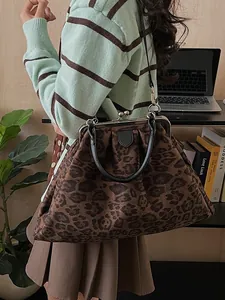 Chic leopard print cloud bag with metal frame clasp and adjustable leather straps