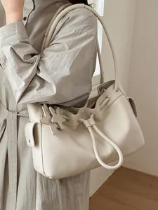 Chic cream leather tote bag with drawstring closure and star charm for women