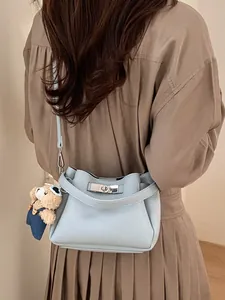 Light blue lychee texture leather bucket bag with cute bear charm and silver twist lock
