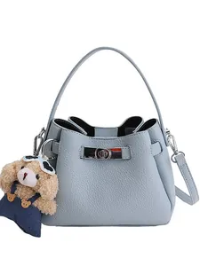 Light blue bucket bag with lychee texture, silver twist lock and cute bear charm
