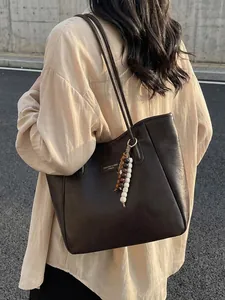Retro dark brown large tote bag with leather texture and wooden bead charm on shoulder